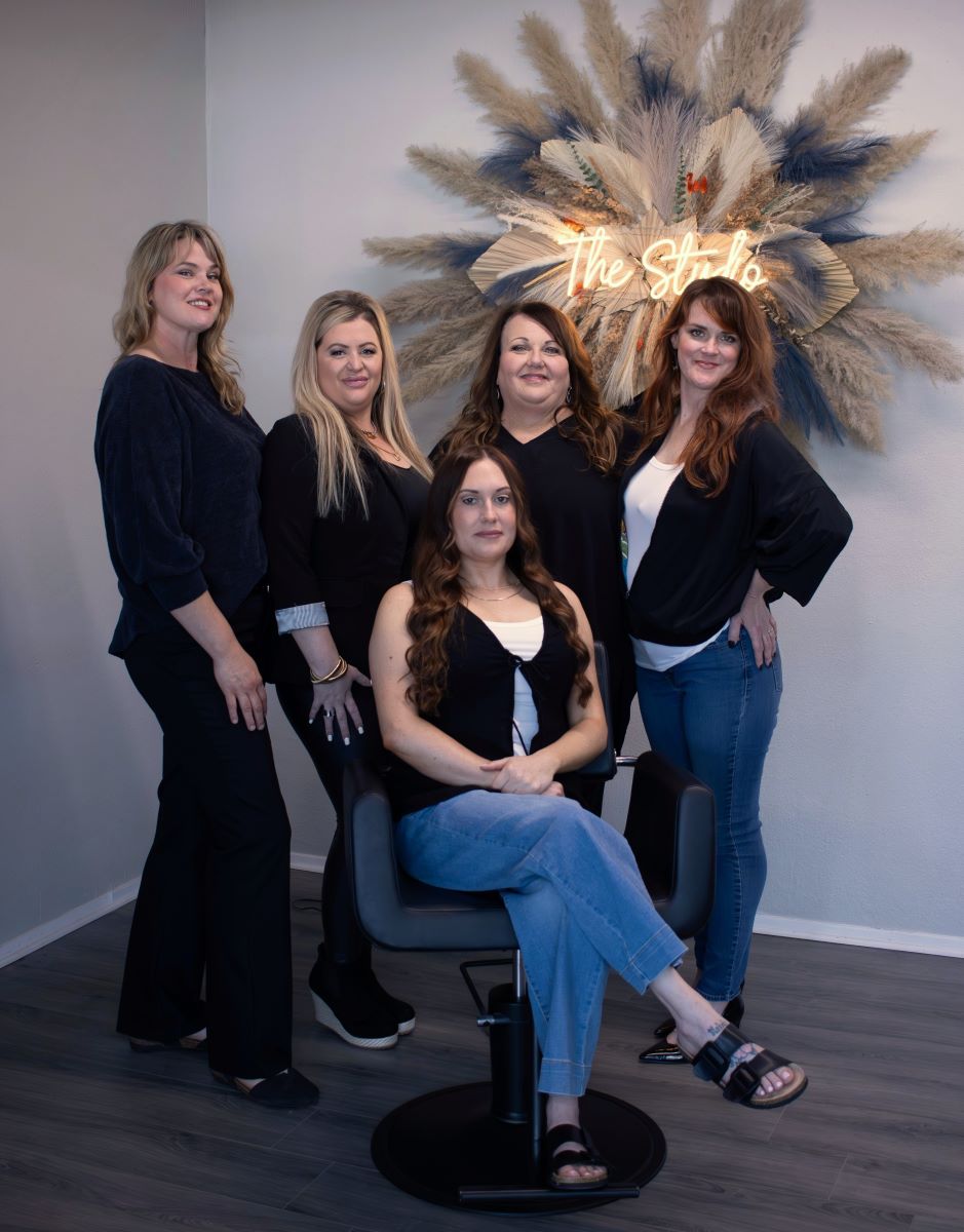 Group photo of the hair stylists and massage therapist at the studio.